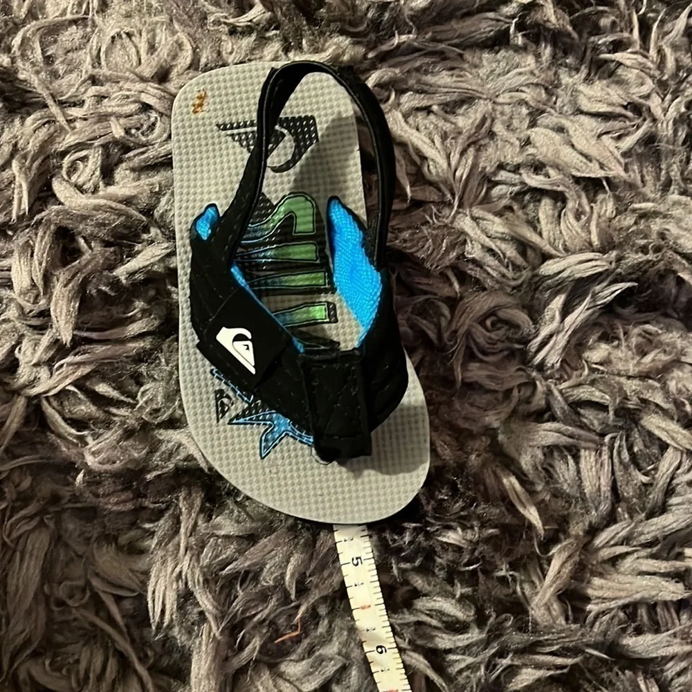 Quicksilver black and blue flip flops for boys.